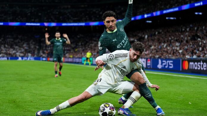 Federico Valverde of Real Madrid is challenged by Omar Marmoush of Manchester City during the UEFA Champions League 2025/26 Round of 16 First Leg match between Real Madrid CF and Manchester City FC at Estadio Santiago Bernabeu on March 11, 2026 in Madrid, Spain.