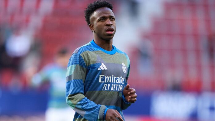 Vinicius Junior of Real Madrid looks on during the warm up prior to the LaLiga EA Sports match between CA Osasuna and Real Madrid CF at Estadio El Sadar on February 21, 2026 in Pamplona, Spain.